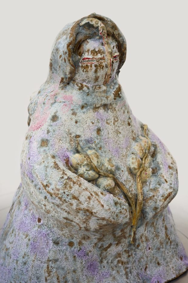 Eternal Memory — hand-built cloaked figure holding a flowering branch, pale mottled glaze.
